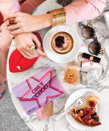 Stella McCartney iPhone case ($75), Saks Fifth Avenue, Palm Beach; Only Choo clutch ($1.025), Vivy 20th sunglasses ($1,000), Jimmy Choo, Palm Beach; rock crystal ring ($6,860), watermelon tourmaline ring ($18,300), 18-karat gold bangles ($950 each), Irene Lummertz Jewelry, Palm Beach; Altuzarra pants ($795), blazer ($1,695), Neiman Marcus, Palm Beach.