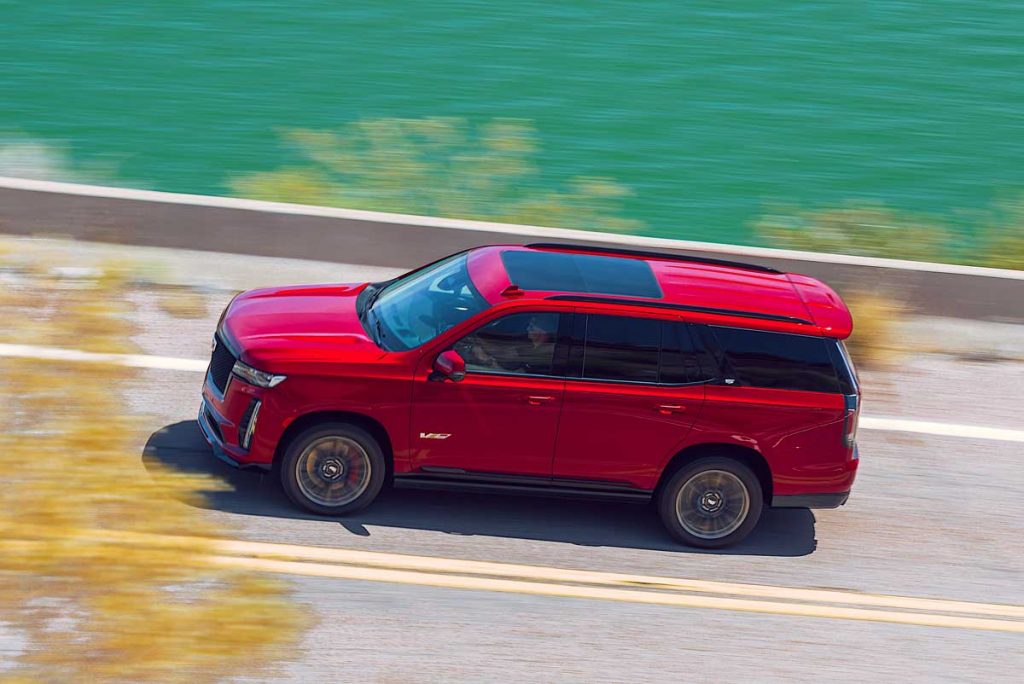 The 2023 Cadillac Escalade-V in motion as it drives down a highway.