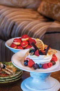 Dessert was wild berry pavlova with orange chips, strawberry cream, chocolate shavings, and micro mint. Photography by Jerry Rabinowitz