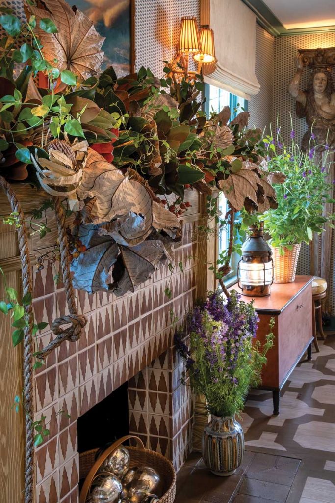 For a holiday party in his newly renovated home, Miller decorated the mantle with smilax, magnolia, paint- ed artichokes, cecropia leaves, jasmine, and banksia