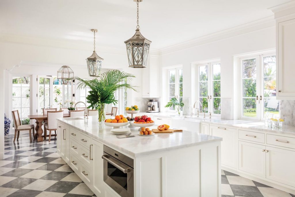 The new light, airy kitchen serves as an ideal communal space with expansive beach views and room for cooking and informal dining. Photo by Nickolas Sargent