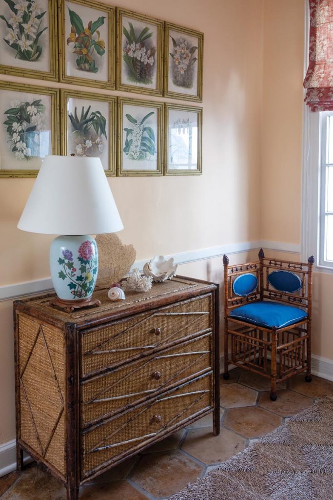 The space pictured includes a dresser, floral art, and a chair all purchased at auction. Photo by Jerry Rabinowitz