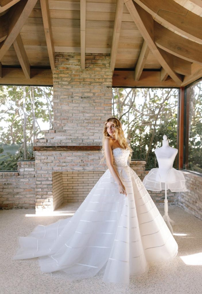 The As You Wish dress features a Belle-inspired hip silhouette that “nods to timeless romance,” says Paige. It contrasts bias-cut stripes with hand-cut floral appliqués. Photo by Rich Lander
