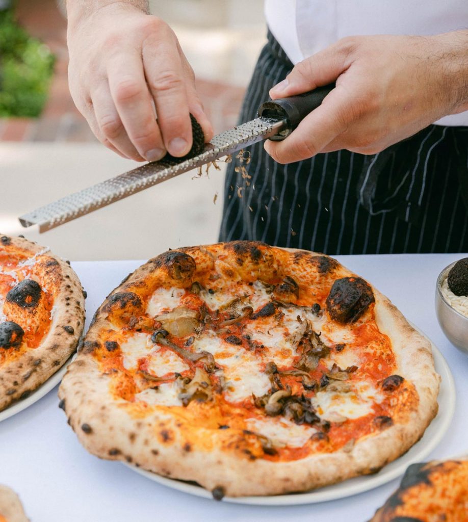On July 4, indulge in pizza from the restaurant's new wood-fired pizza oven, barbecue stations, premium steaks, house-made sausages, and porchetta. Photo courtesy of Café Boulud