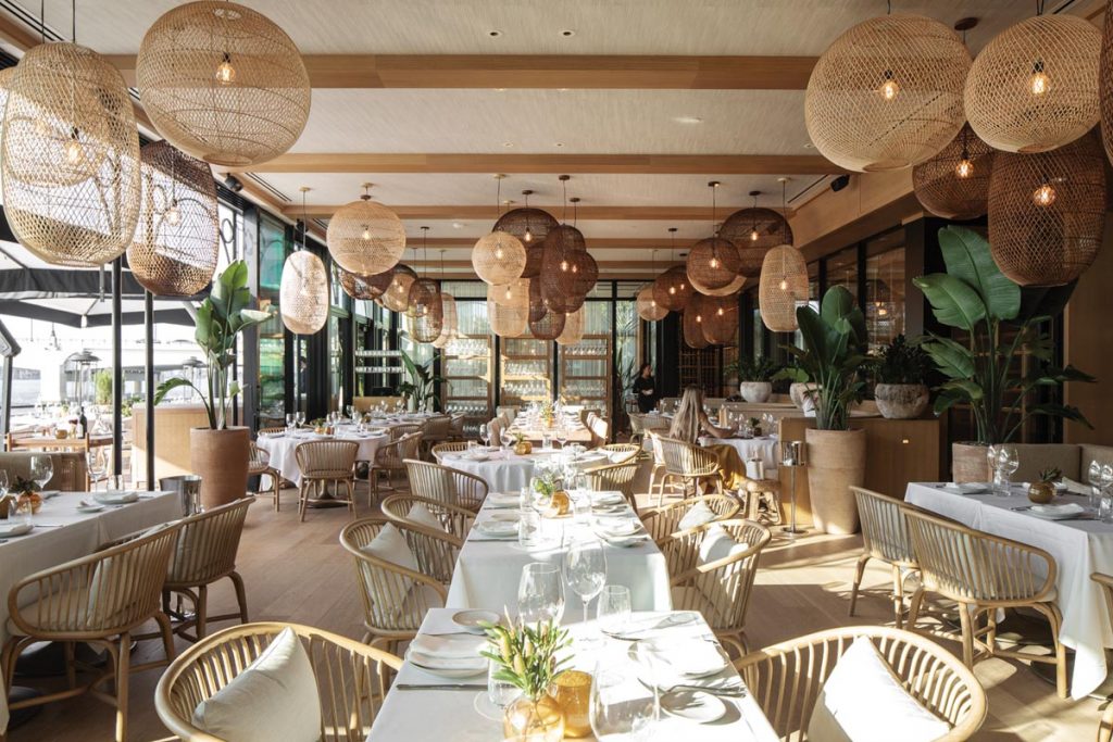 Tutto Mare embraces a coastal sensibility with rattan-rich decor. Photo by Eric Striffler