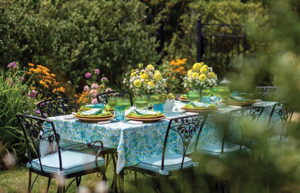 Inspired by daisy-printed linens she found at an estate sale, Meg Braff embraced a blue, green, and yellow color palette for this summertime setup at her Locust Valley home. Photo by Eric Striffler