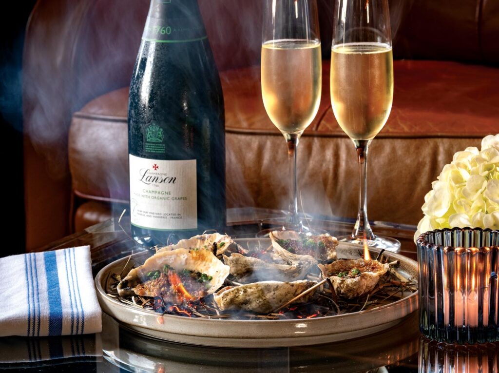 The meal kicked off with bourbon and hay-roasted oysters. Photo by Jerry Rabinowitz